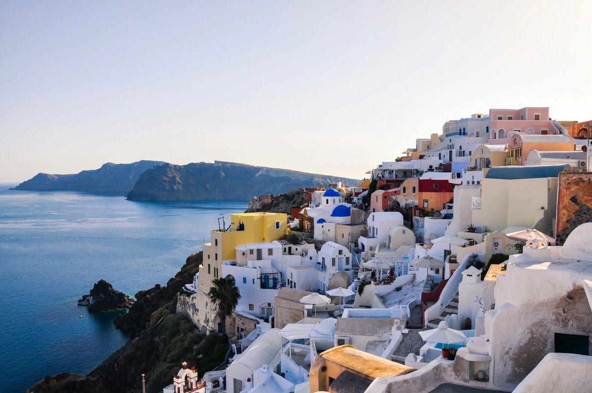 Whitewashed houses on a cliff above the Aegean